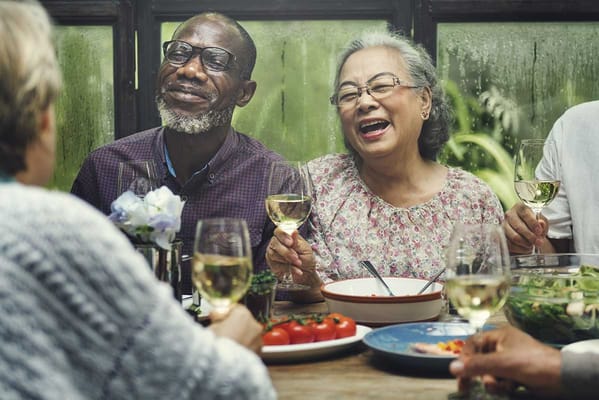 Residents enjoying a meal together with drinks