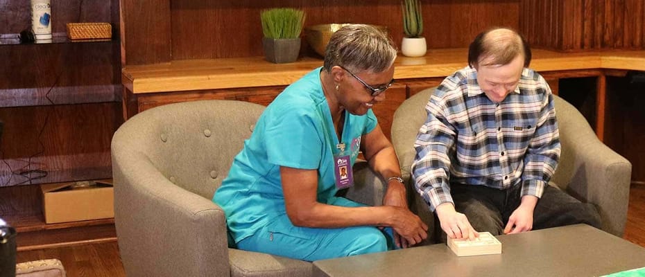 Staff member engaging with resident in a common area