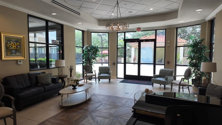 Spacious lobby with seating and natural light at Excellence Senior Living