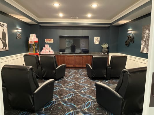 Cozy interior view of a movie room with recliners