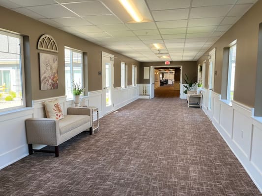Bright and welcoming interior corridor with seating area