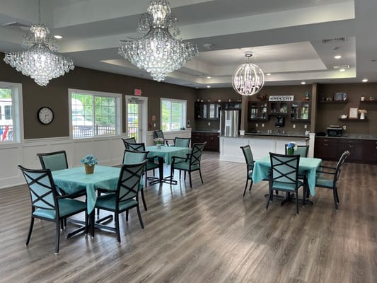 Bright common area with tables and chandeliers