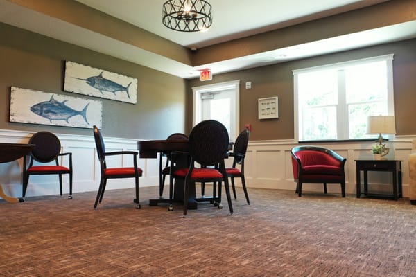 Seating area in common room featuring tables and chairs