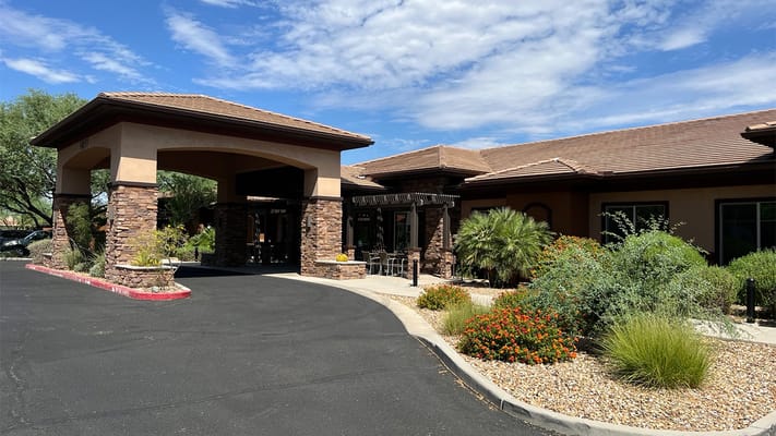 Exterior view of a senior living facility with landscaping