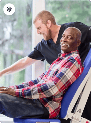 Resident smiling during a therapy session with staff member