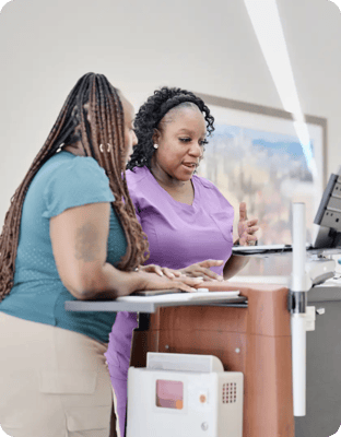 Staff assisting a resident at a facility