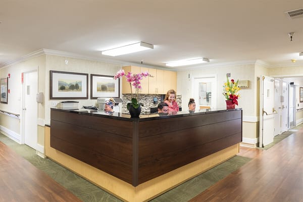 Reception area with staff and residents interacting