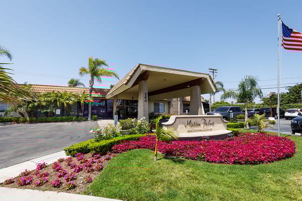 Exterior view of Mission Palms Healthcare Center with landscaping