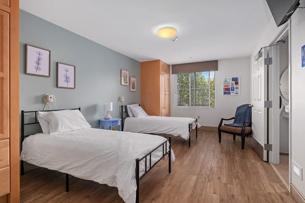 Bright interior of a shared resident room with two beds