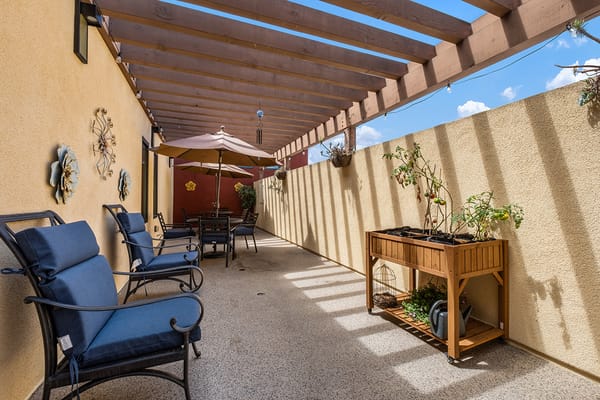 Outdoor patio area with seating and plants