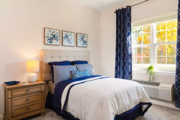 Cozy interior of a private resident room with a bed and natural light
