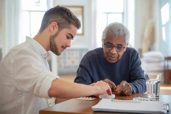 A young man and an older gentleman playing a game.