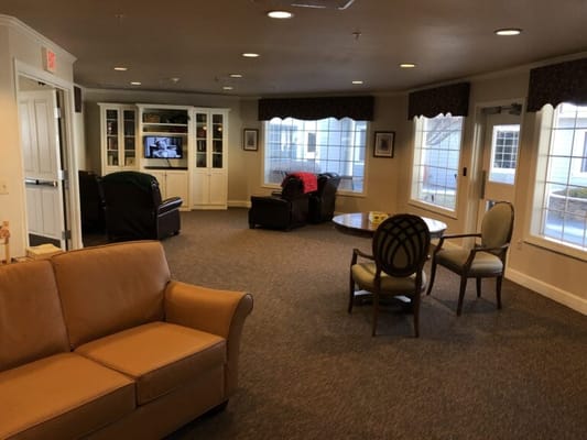 A cozy common area with seating and windows