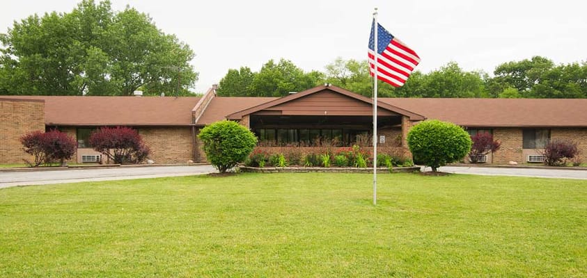 Exterior view of the senior care facility with manicured lawn