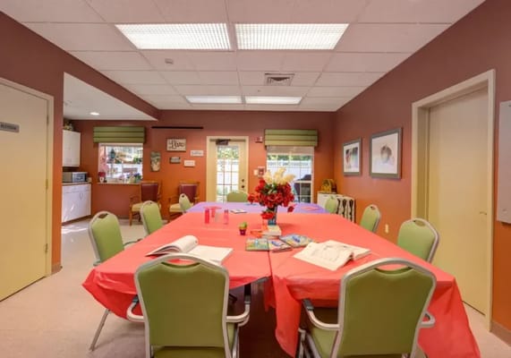 Bright common area with tables and flowers