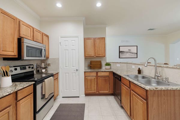 Modern kitchen with wooden cabinets and stainless appliances