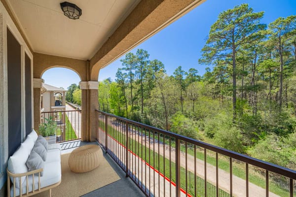 Balcony view overlooking a wooded area