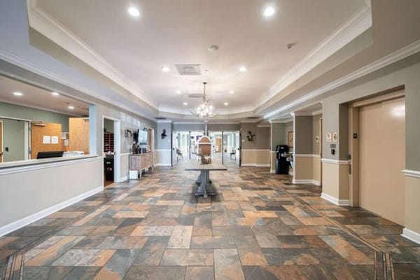 Bright lobby area with stone flooring and seating