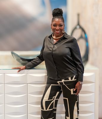 A staff member posing in a well-lit common area