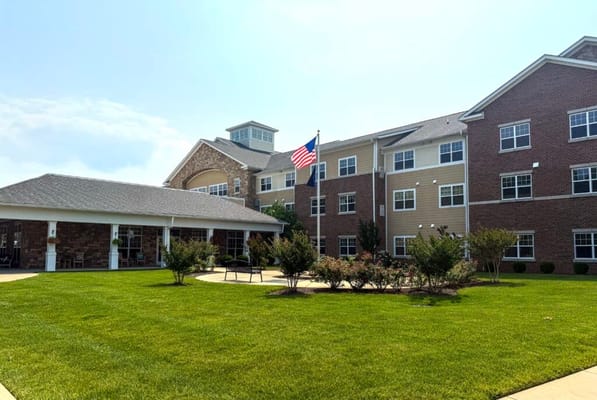 Exterior view of a senior living facility with landscaped grounds