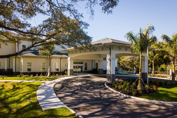 Entrance of a senior living facility with landscaping