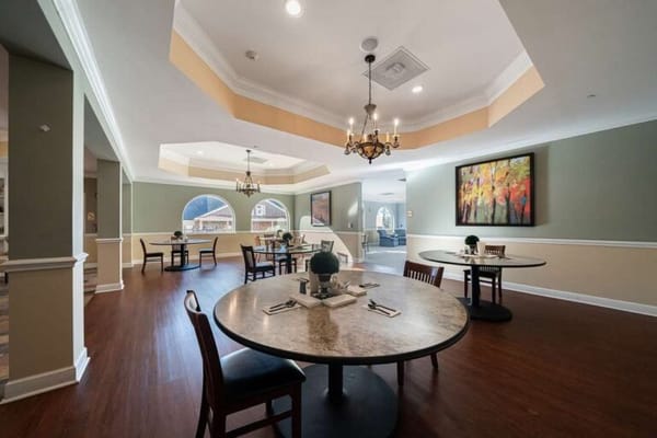 Bright dining area with tables and artwork