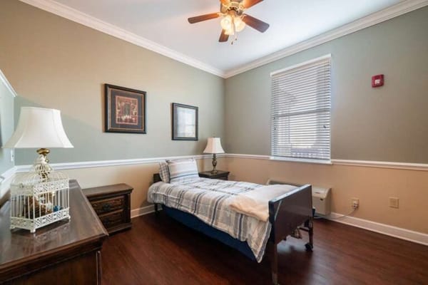 Cozy private resident room with bed and lamp