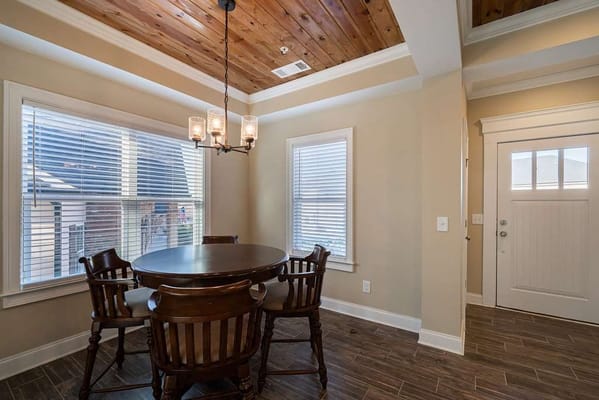 Bright dining area with wooden ceiling and table