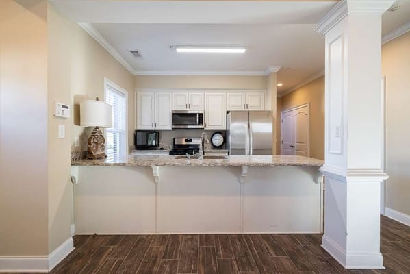 Modern kitchen area with granite countertops