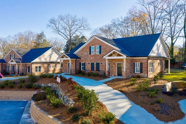 Exterior view of a senior living facility surrounded by greenery