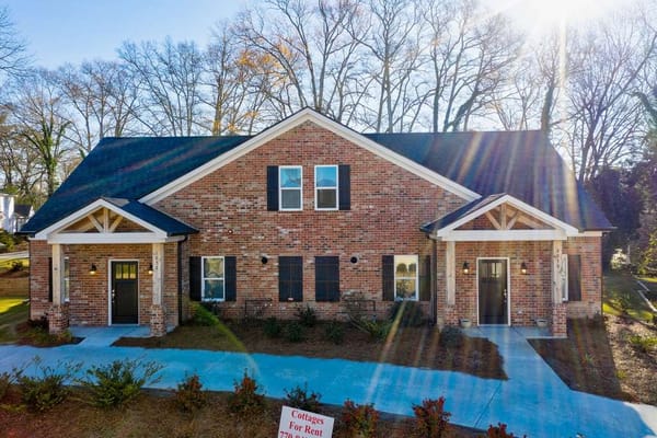 Front view of a senior living building with landscaped paths