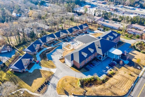 Aerial view of a senior living facility with walking paths