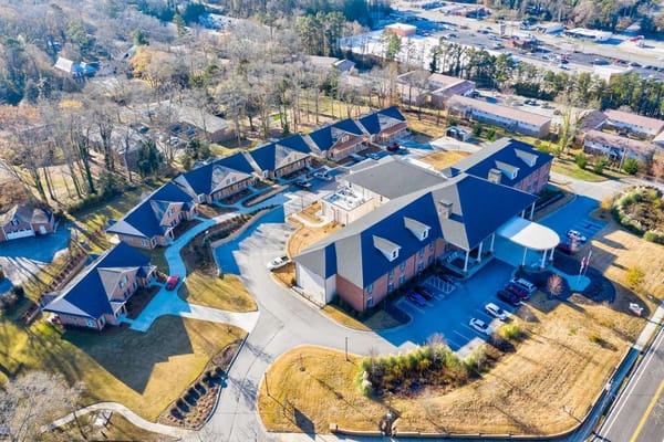 Aerial view of a senior living facility with walking paths