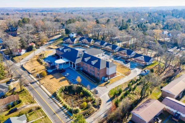 Aerial view of a senior living facility with surrounding grounds