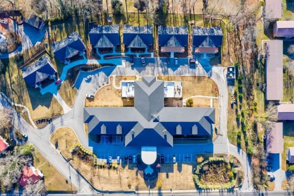 Aerial view of a senior living facility with surrounding outdoor space