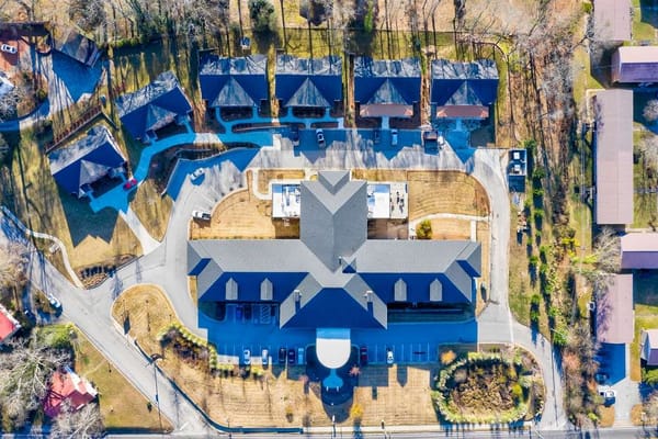 Aerial view of a senior living facility with surrounding outdoor space