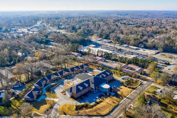 Aerial view of a senior living facility surrounded by trees