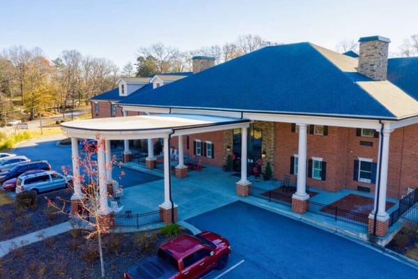 Aerial view of the facility entrance with parking area