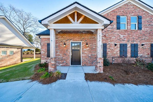 Front entrance of a senior living facility with landscaped walkway