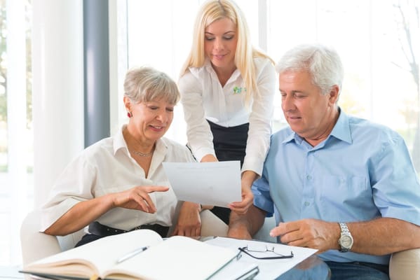 A staff member assisting seniors with paperwork