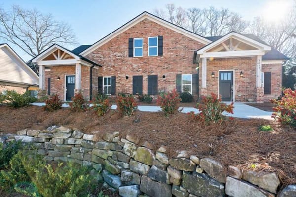 Exterior view of a senior living facility with landscaping