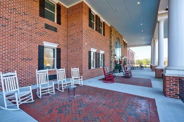 Entrance area with rocking chairs and brick pathways