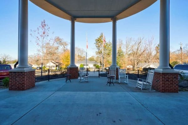 Covered outdoor seating area with rocking chairs
