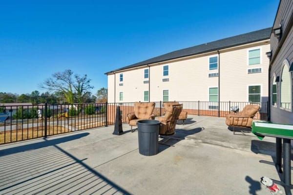 Outdoor seating area with sunshine and a view