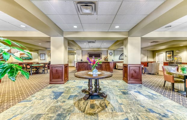 Bright lobby area with seating and decorative flowers