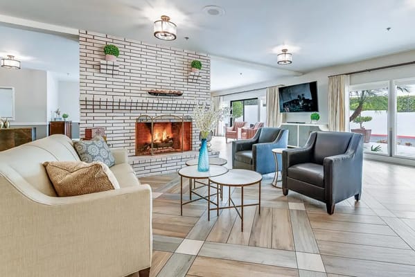 Interior view of a cozy common area with a fireplace