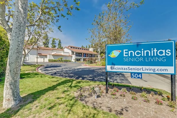 Exterior view of Encinitas Senior Living facility with sign