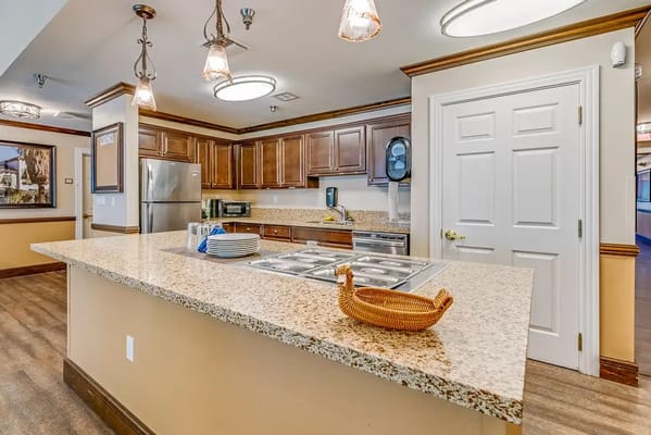 Bright kitchen area with modern fixtures and cabinets