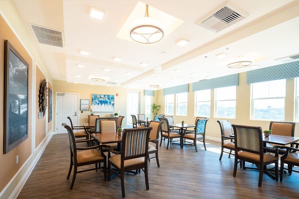 Dining area with tables and chairs in a bright room
