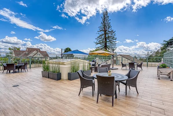 Outdoor patio area with seating and umbrellas